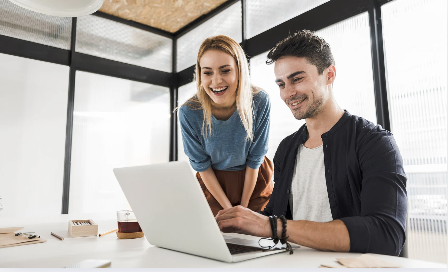 two people looking at a laptop together